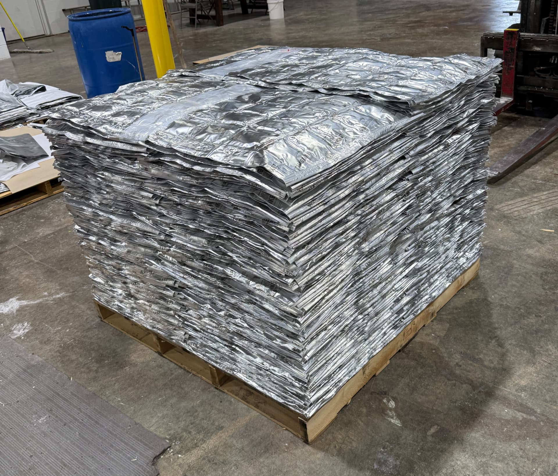 Pallet of stacked EnigMat PCM blankets in a warehouse